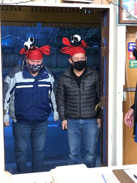Lions staff ready for crab meal pickup with whimsical crab hats